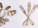 four different types of silver spoons and forks on a white surface