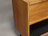 a wooden cabinet with a black drawer on it