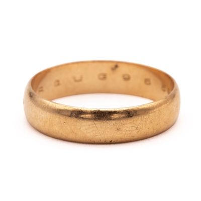 a close up of a gold ring on a white background