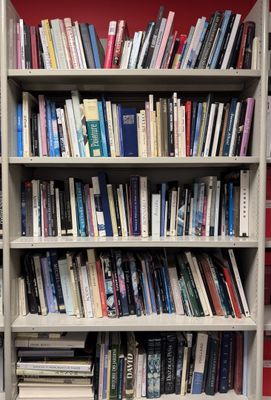 a book shelf with many books on it in a room