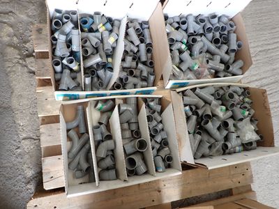 many pipes in a box on a wooden pallet