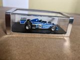 a small toy car in a clear box on a table