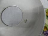 a plate with a flower design on it sitting on a table