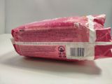 a pink bag of food sitting on a table