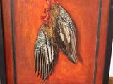 a picture of a painting of two birds hanging on a wall