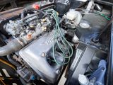 a close up of a car ' s engine with its hood open