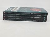 three books stacked on top of each other on a white surface