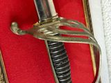 a sword hanging on the wall with a red background