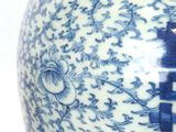 a blue and white vase with a chinese writing on it