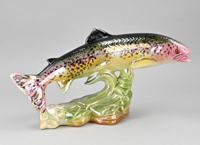 a figurine of a fish that is jumping out of the water