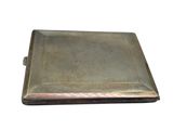 an antique silver cigarette case with a metal cover on a white background