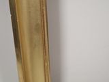 a picture of a gold framed mirror on the wall