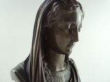 a statue of a woman with a veil on her head