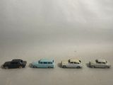 several toy cars are lined up in a row on a white surface