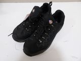 a pair of black shoes on a white surface