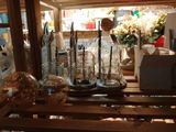 a wooden shelf with a bunch of glass vases on it