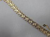 a close up of a gold bracelet with purple stones on it