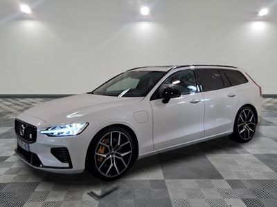 the volvo wagon is parked in a large room with a checkered floor