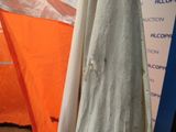 a dress hanging on a hanger in front of a tent