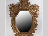 an ornate gold mirror with flowers and leaves on a white background