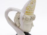 a white cup with a gold crown on top of it