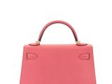a pink leather handbag on a white background