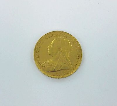 gros plan d'une pièce d'or sur une surface blanche