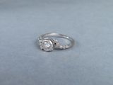 a close up of a diamond ring on a blue surface