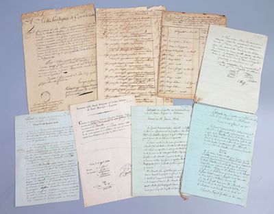 several old papers are stacked on top of each other on a blue surface
