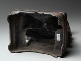 a small statue of a man sitting in a box