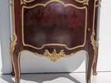 a brown and gold cabinet with a mirror on it