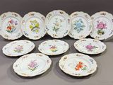 many plates with different designs on them on a table