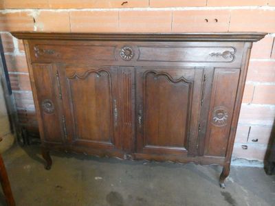 a very old wooden cabinet in the corner of the room