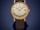 a gold plated wrist watch with a white dial and brown leather strap