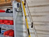 a ladder that is leaning against a wall with tools on it