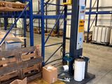 un grand entrepôt avec des palettes et des cartons posés à même le sol