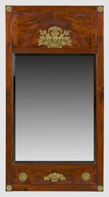 a wooden mirror with a gold leaf decoration on it