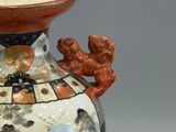 a vase that has a picture of people on it