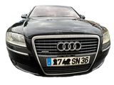 a black car that is parked on the side of the road