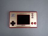 a red and gold gameboy sitting on a table