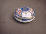 a close up of a small blue and white box with a tag on it