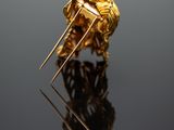 an image of a close up of a gold ring on a reflective surface