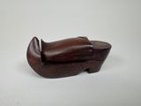 a wooden shoe box sitting on top of a white surface