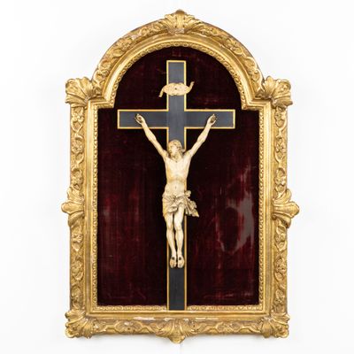 a gold framed crucifix with a cross on it