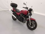 a red motorcycle that is parked in a room