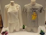 two t - shirts that are on display on a table