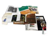 a lot of books that are open on a white surface