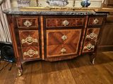 a dresser with a marble top in a room