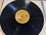 an old record with a yellow label on it sitting on a table