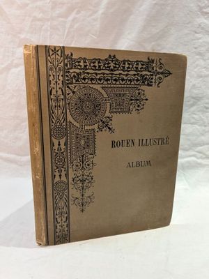 an old book sitting on top of a white cloth covered table